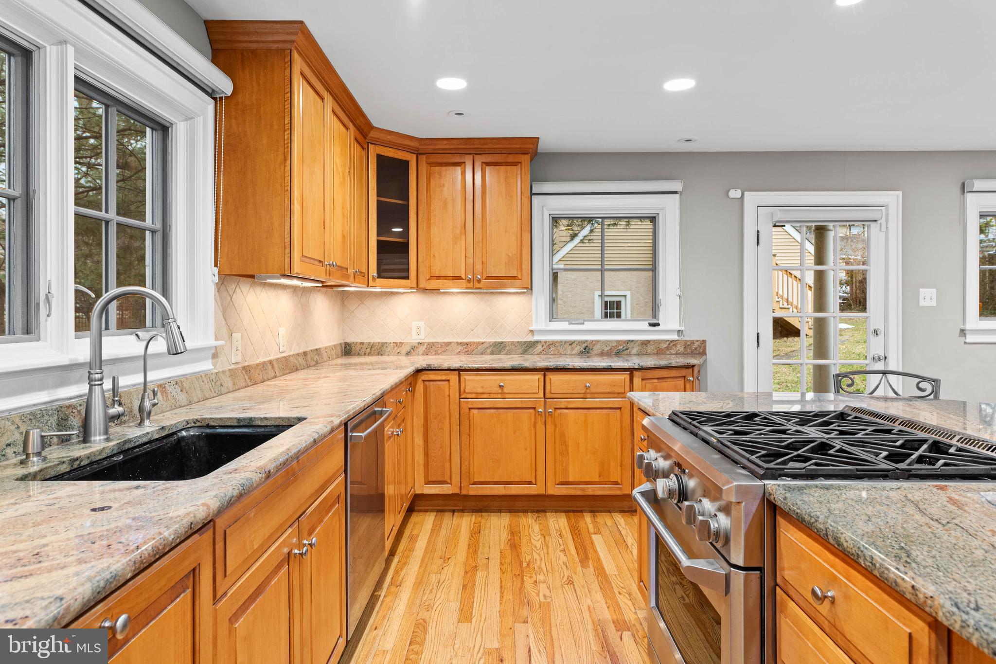 214 Roberts Road Ardmore, PA 19003 - Photo 19 of 63 a kitchen with granite countertop a sink stove and cabinets