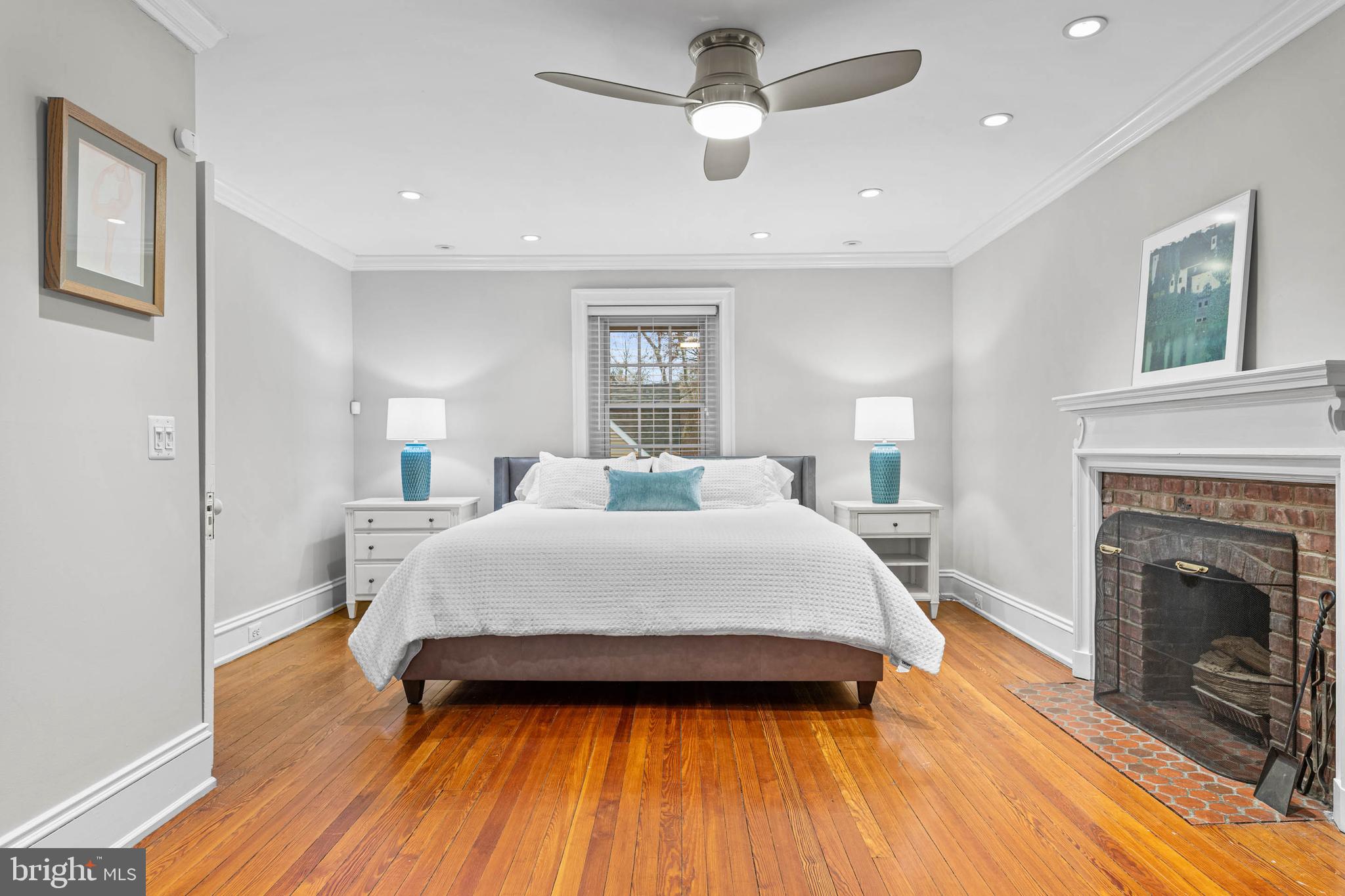 214 Roberts Road Ardmore, PA 19003 - Photo 26 of 63 a spacious bedroom with a bed and a fireplace