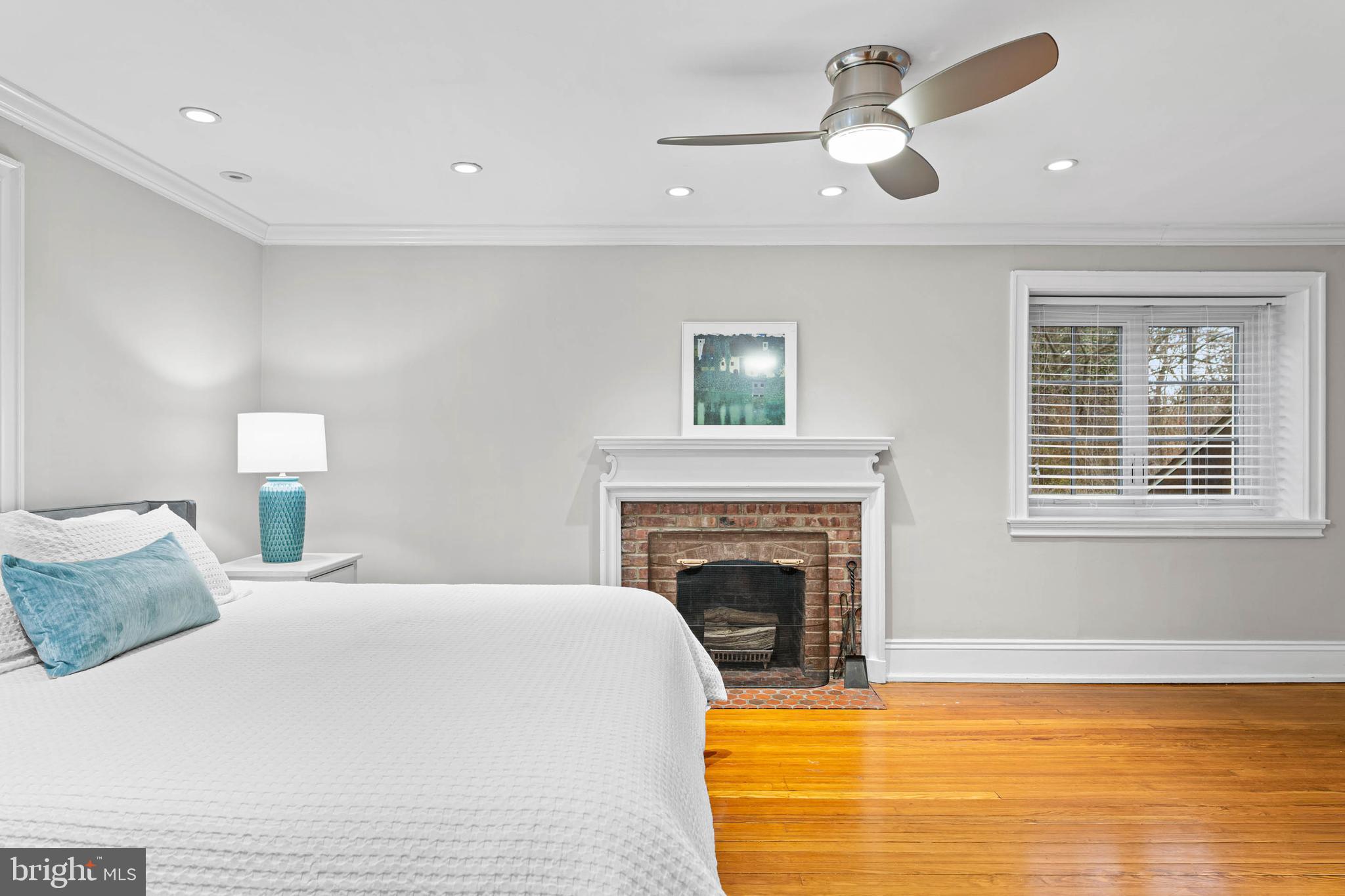 214 Roberts Road Ardmore, PA 19003 - Photo 28 of 63 a bedroom with a bed and a fireplace