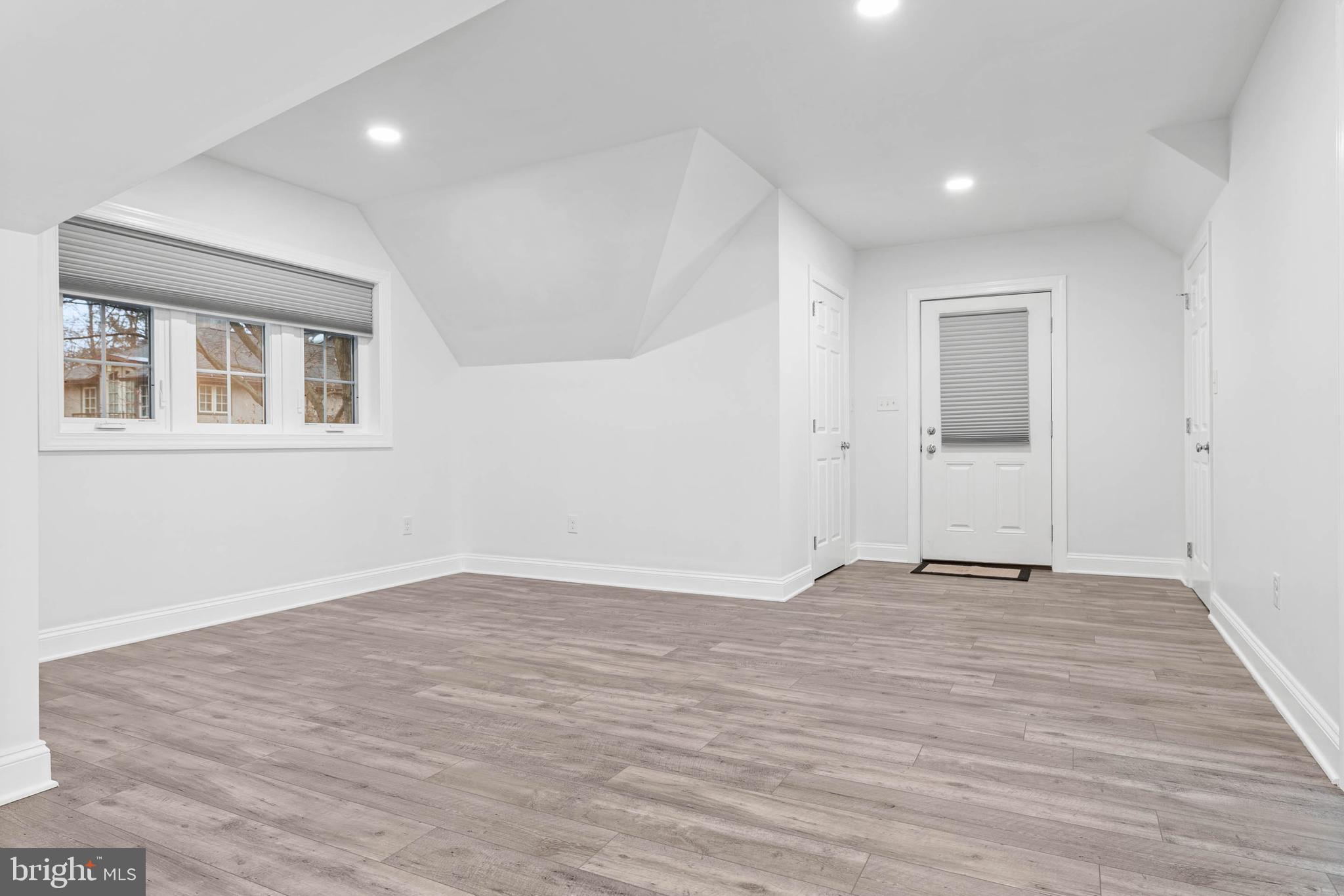 214 Roberts Road Ardmore, PA 19003 - Photo 45 of 63 an empty room with wooden floor and windows