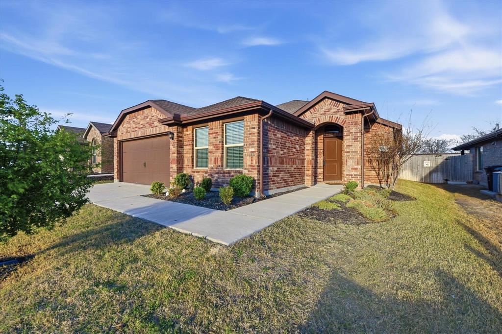 9308 Desertrock Road Fort Worth, TX 76131 - Photo 1 of 29 a view of a house with a small yard and potted plants