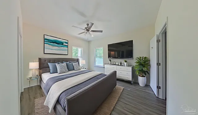 a bedroom with a bed and a flat screen tv