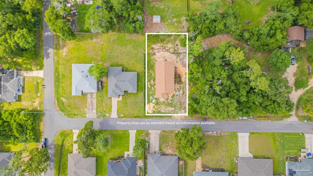 an aerial view of a swimming pool with a yard