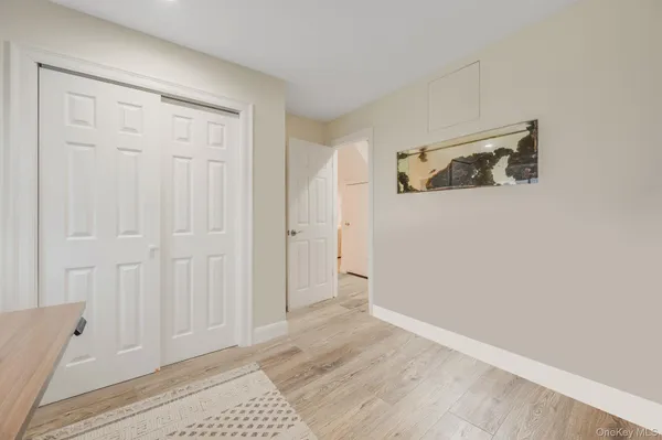 a spacious bedroom with a bed and a potted plant