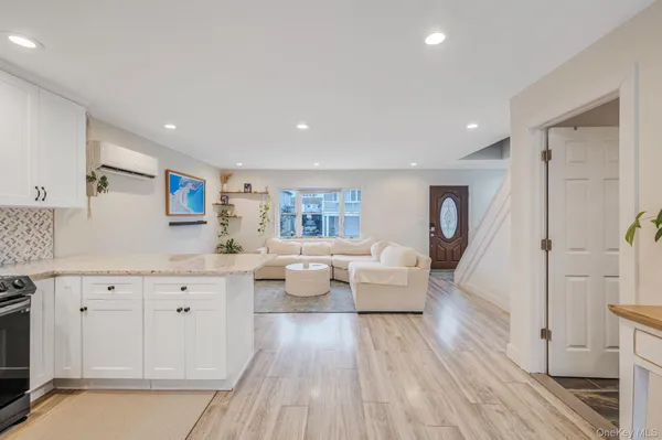 a kitchen with a refrigerator a microwave oven a sink and chairs