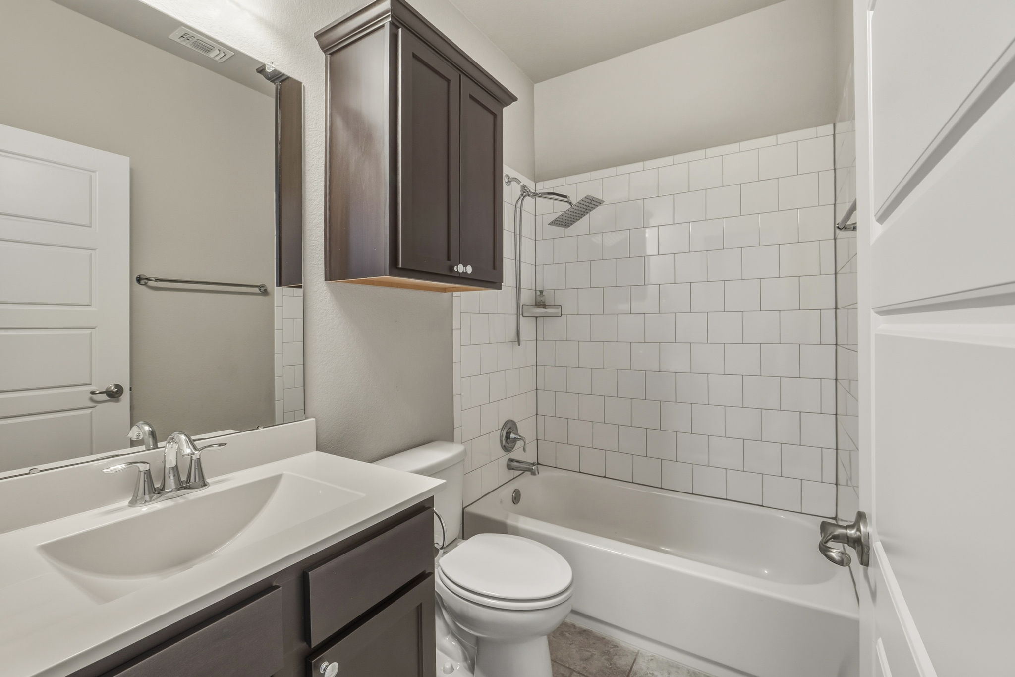 3919 Vaughan Street Austin, TX 78723 - Photo 37 of 40 A well-appointed bathroom features a crisp white subway-tiled shower over a pristine tub.