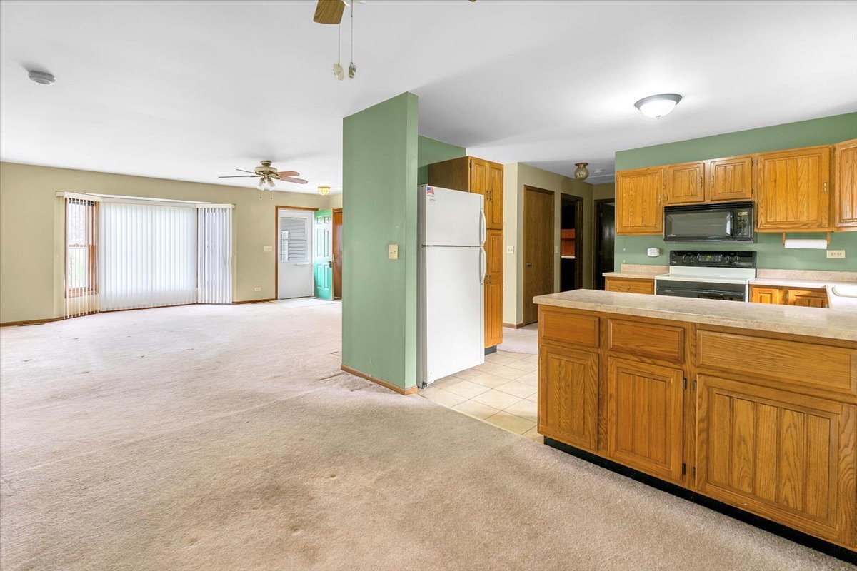 1200 2nd Street Harvard, IL 60033 - Photo 4 of 22 a kitchen with stainless steel appliances granite countertop a refrigerator a stove top oven a sink and dishwasher
