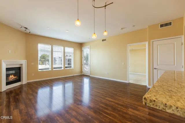 a kitchen with stainless steel appliances a refrigerator and a stove top oven
