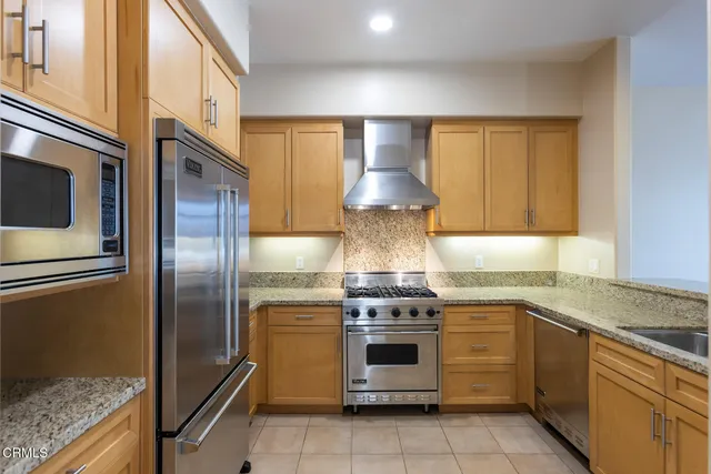 a kitchen with a stove oven and sink