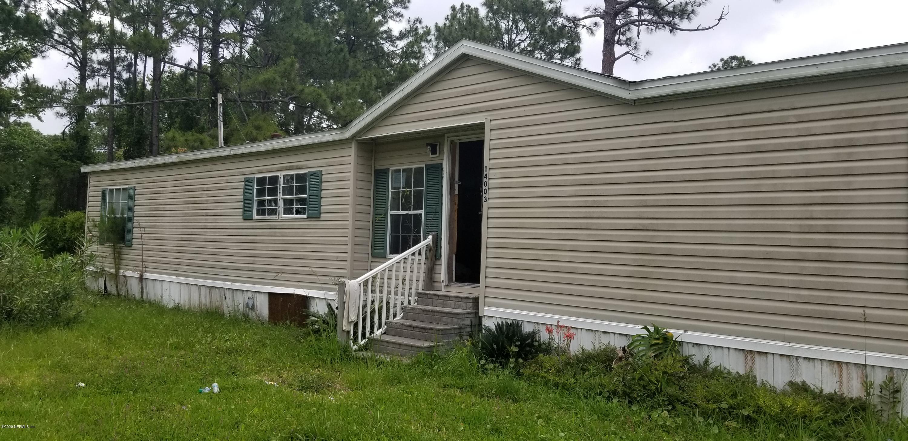 a view of a house with a yard and a garage