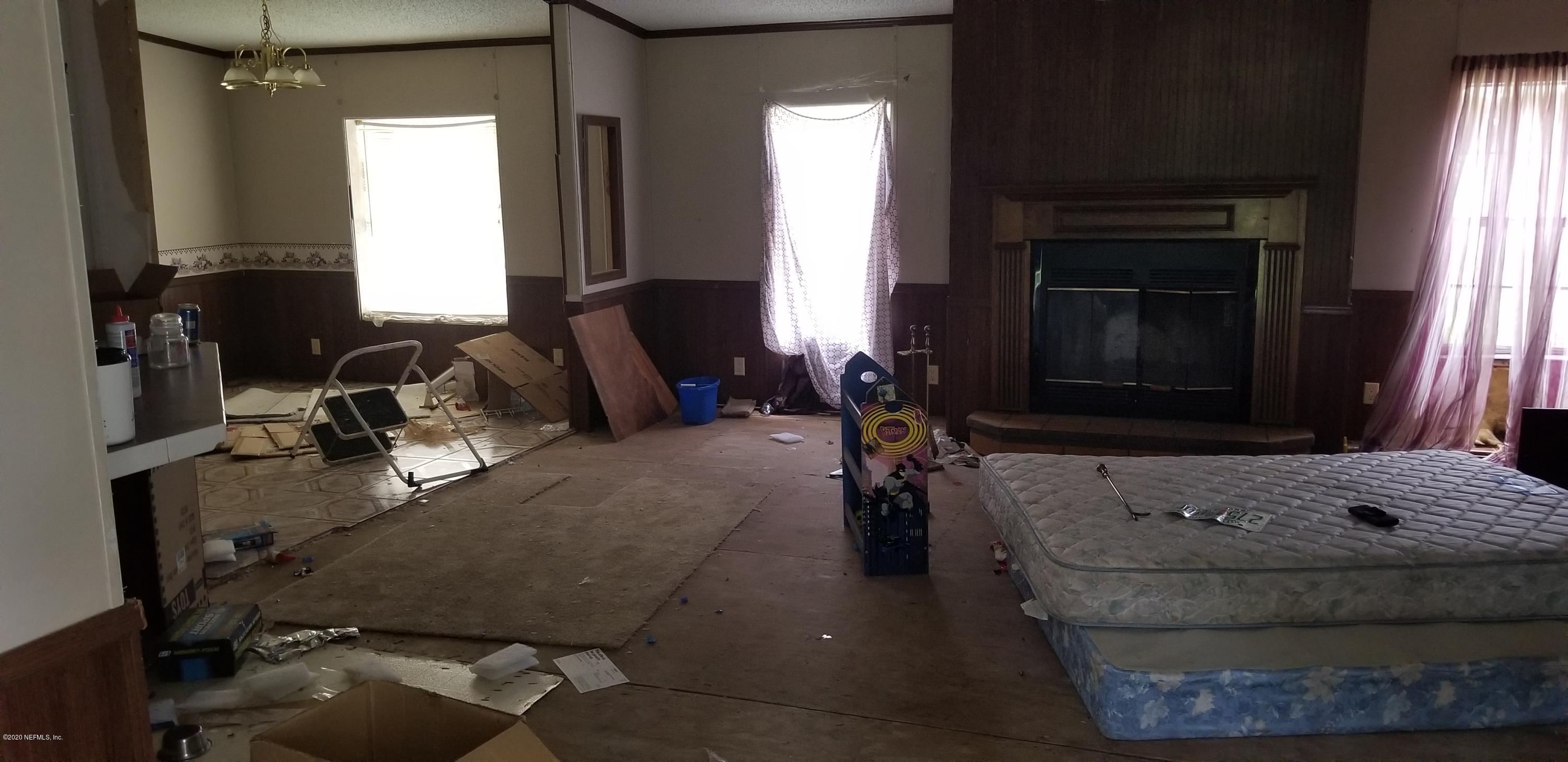 14003 Bradham Road Jacksonville, FL 32226 - Photo 12 of 30 a living room with furniture and a fireplace