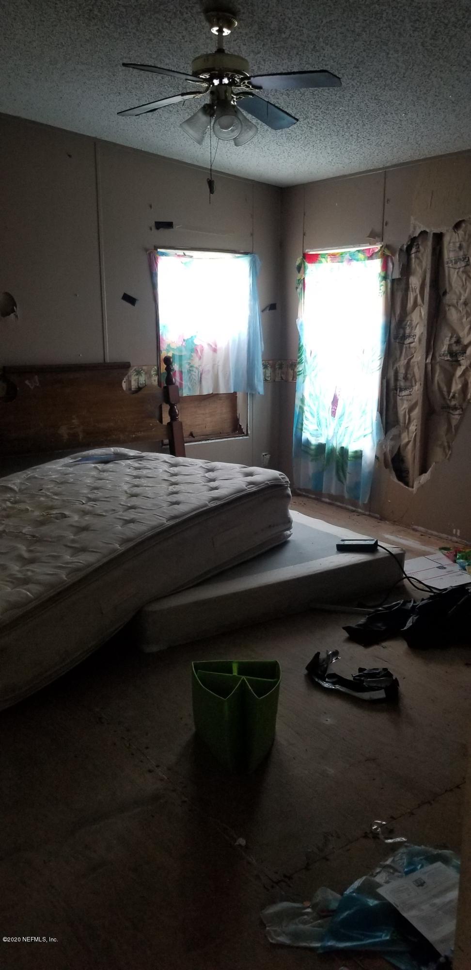 14003 Bradham Road Jacksonville, FL 32226 - Photo 14 of 30 a kitchen with a table chairs and a stove