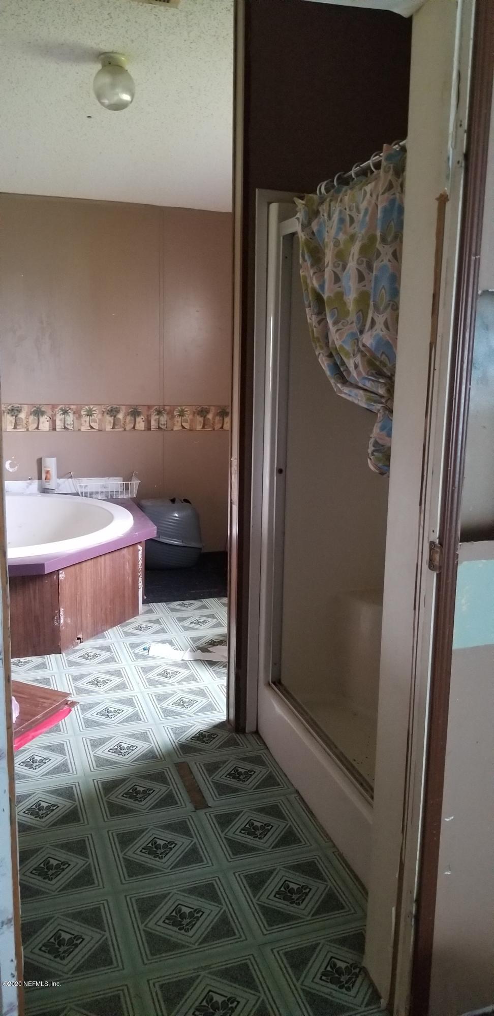 14003 Bradham Road Jacksonville, FL 32226 - Photo 15 of 30 a bathroom with a sink and a shower