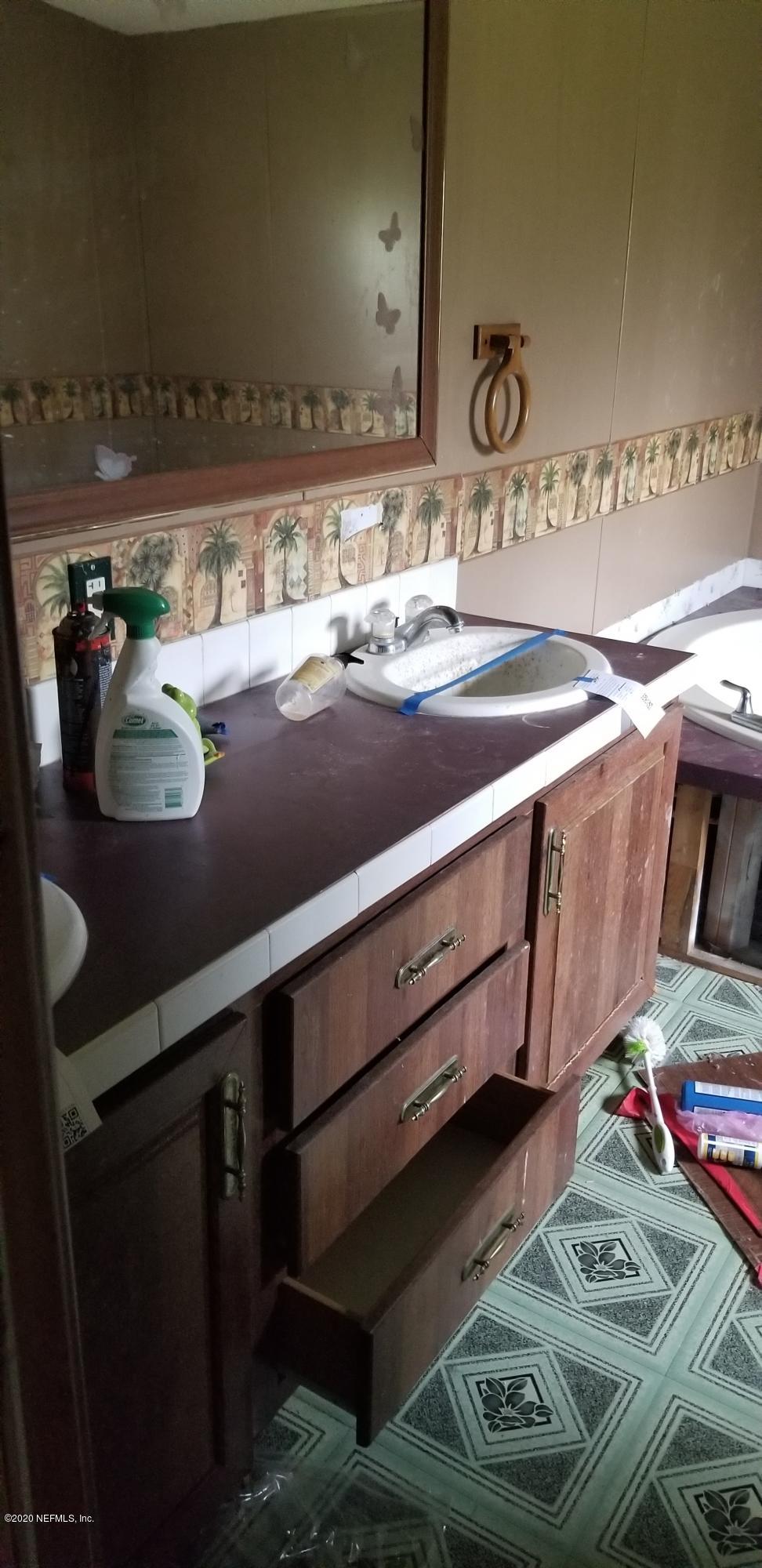 14003 Bradham Road Jacksonville, FL 32226 - Photo 16 of 30 a bathroom with a sink and a mirror