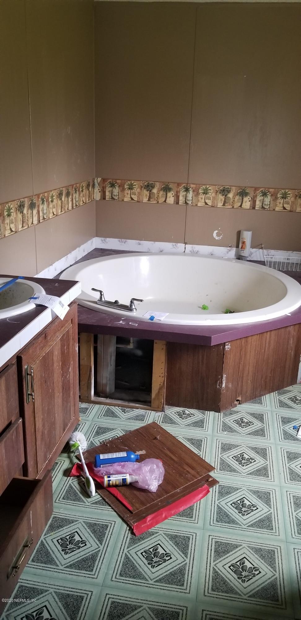 14003 Bradham Road Jacksonville, FL 32226 - Photo 17 of 30 a bathroom with a sink and a mirror