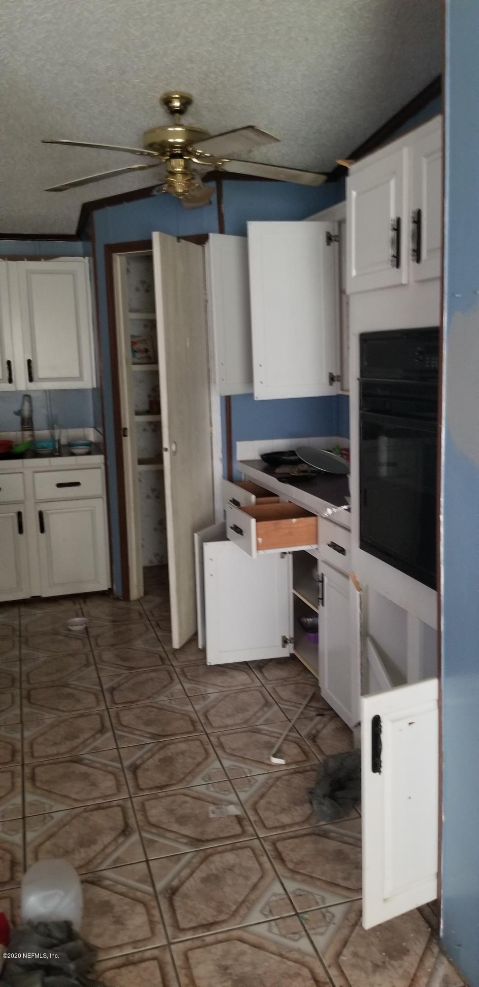 14003 Bradham Road Jacksonville, FL 32226 - Photo 21 of 30 a kitchen with stainless steel appliances a stove and cabinets