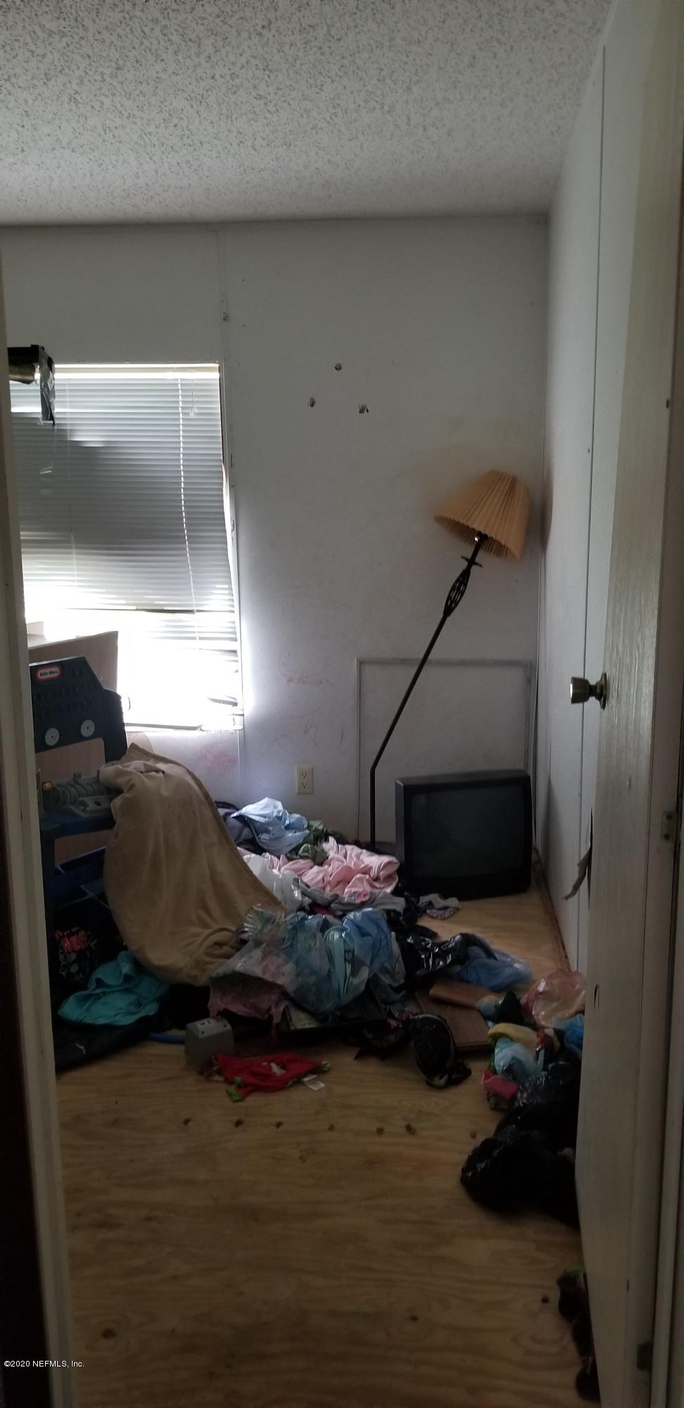 14003 Bradham Road Jacksonville, FL 32226 - Photo 27 of 30 a living room with furniture and a wooden floor