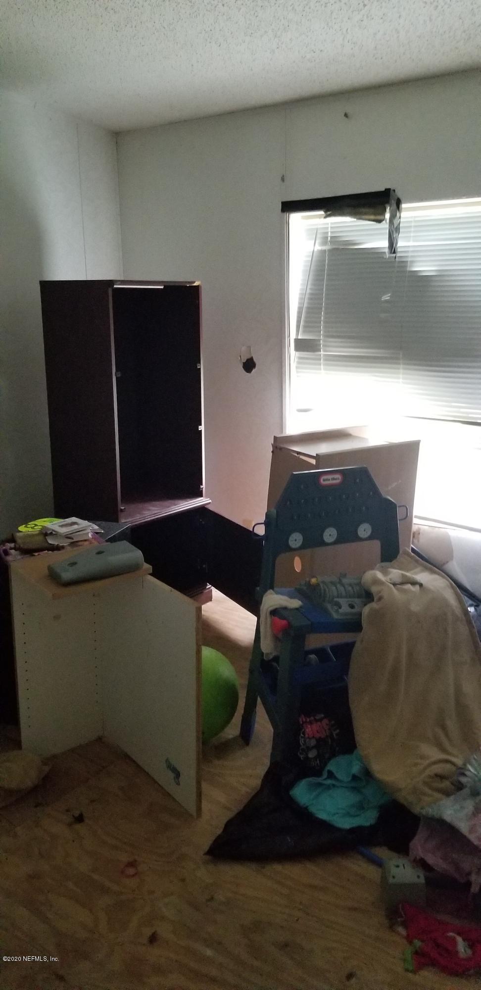 14003 Bradham Road Jacksonville, FL 32226 - Photo 28 of 30 a living room with furniture and a air conditioner vent