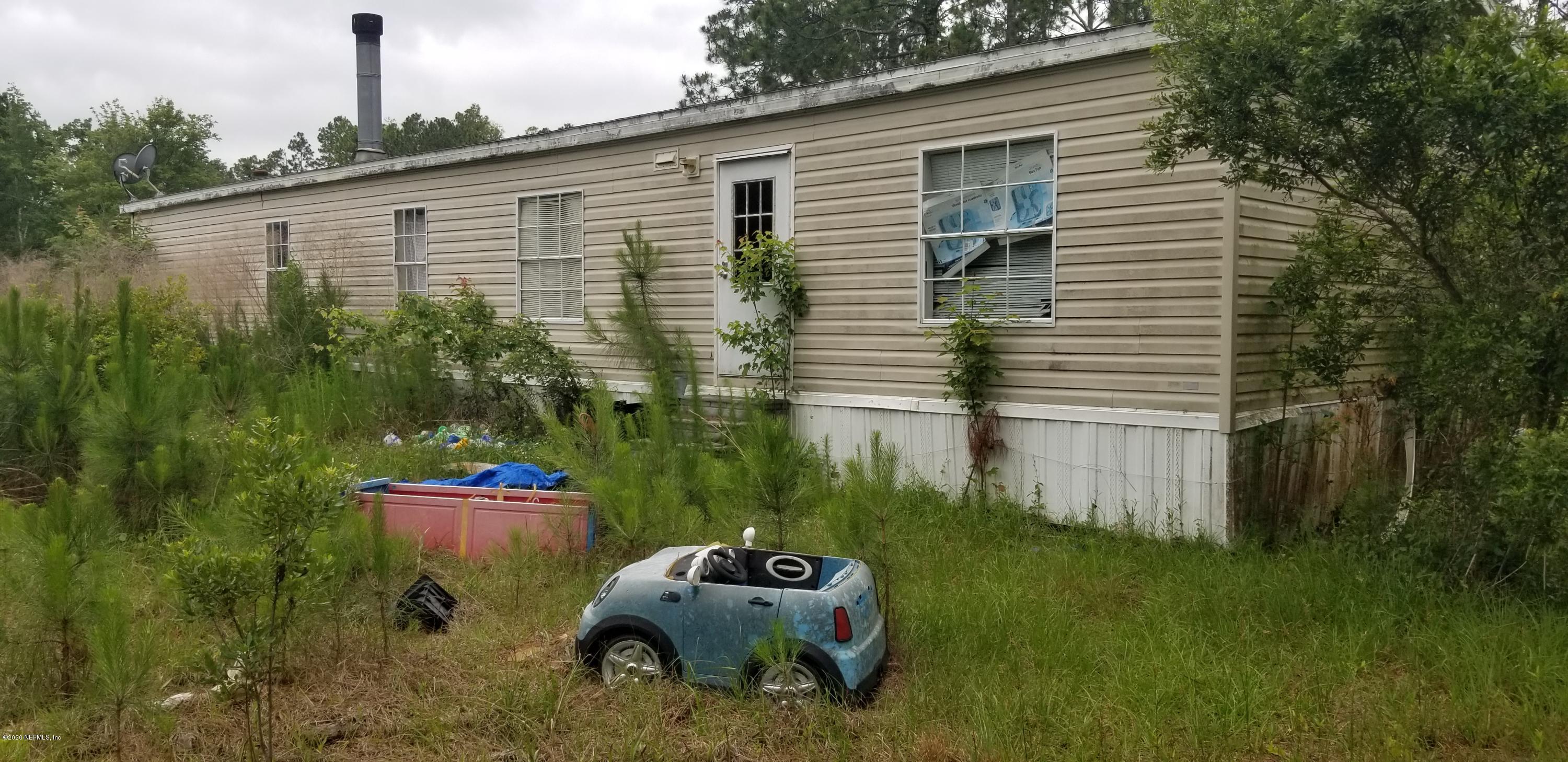 14003 Bradham Road Jacksonville, FL 32226 - Photo 7 of 30 a front view of a house with a garden