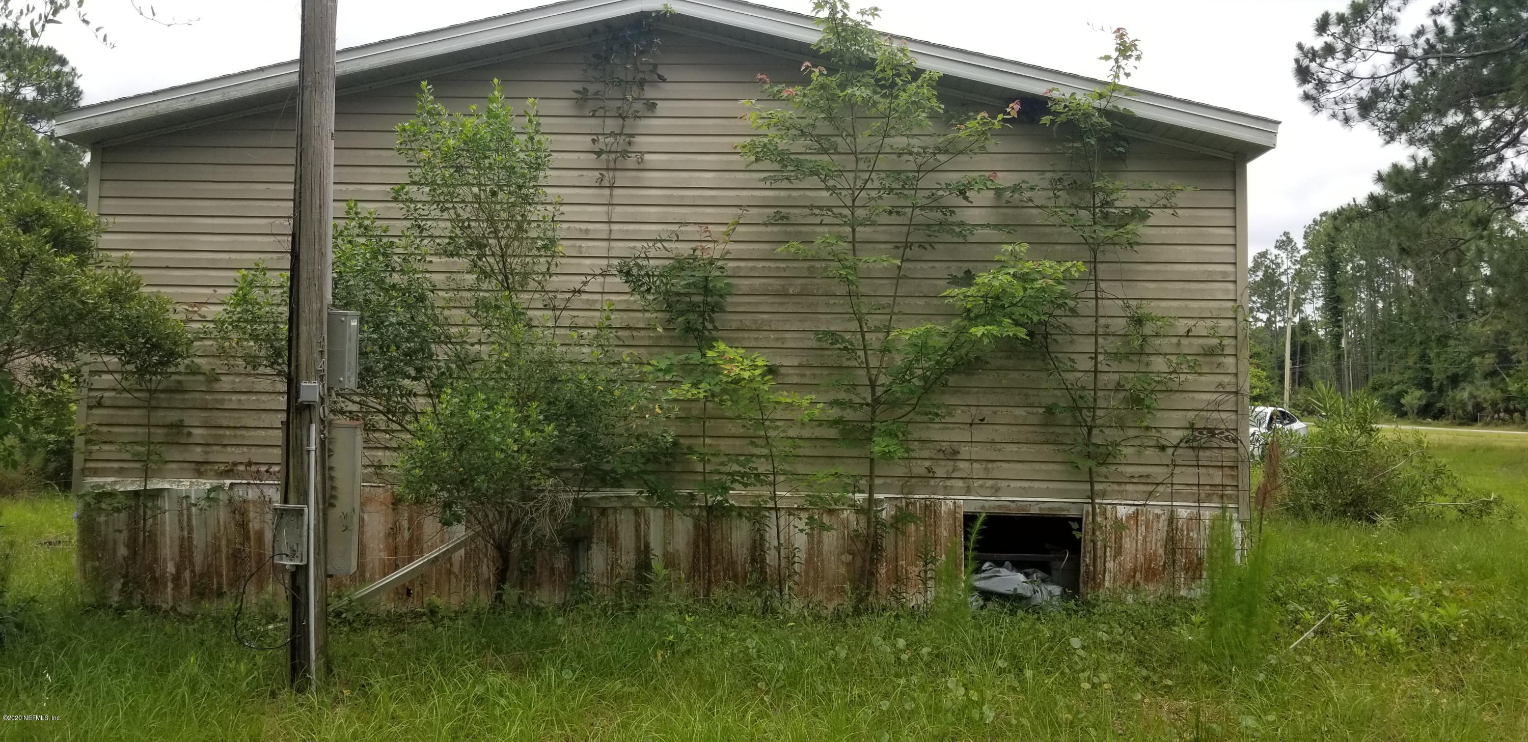 14003 Bradham Road Jacksonville, FL 32226 - Photo 8 of 30 a backyard of a house with lots of green space