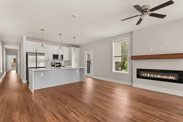 a view of kitchen with sink microwave refrigerator and stove