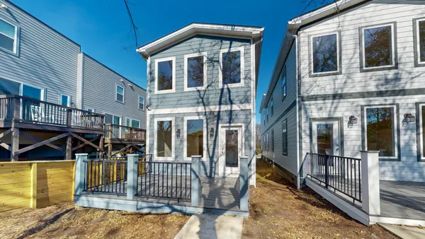 a kitchen with kitchen island a sink stainless steel appliances and cabinets