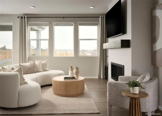 a living room with furniture fireplace and flat screen tv