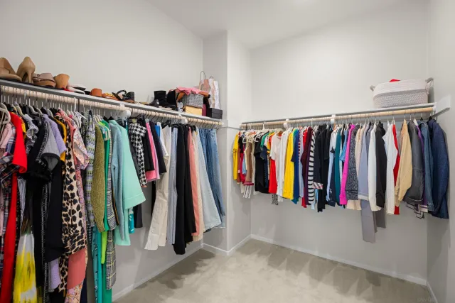 a view of walk in closet with clothes