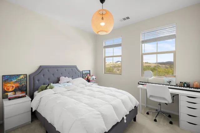 a bedroom with a bed and a window