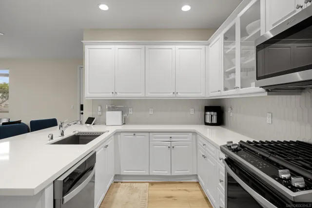 a kitchen with a sink stove and microwave