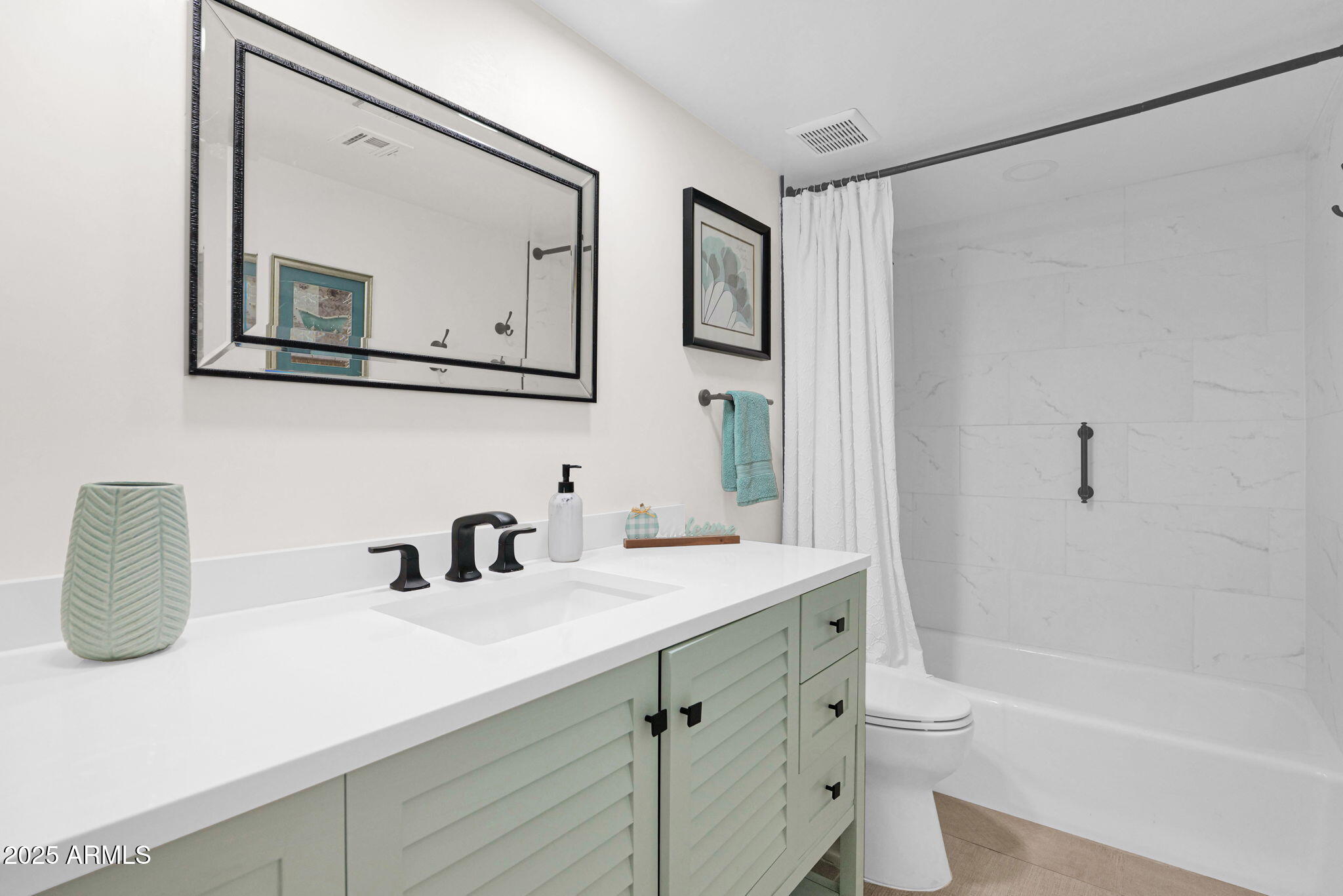 501 East Calavar Road Phoenix, AZ 85022 - Photo 24 of 50 a bathroom with a double vanity sink toilet mirror and bathtub