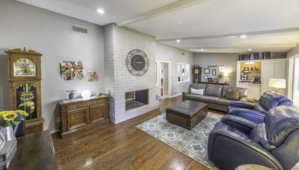 3620 93rd Street Lubbock, TX 79423 - Photo 7 of 33 a living room with furniture and a fireplace