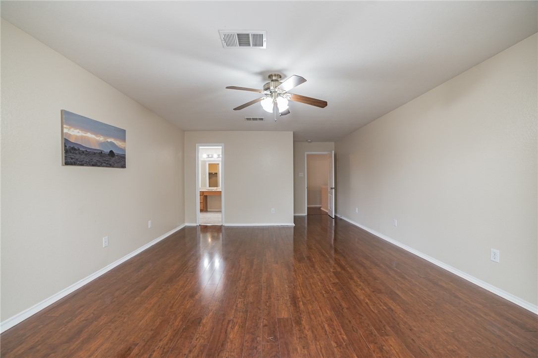 11228 Pickard Lane Austin, TX 78748 - Photo 24 of 32 a view of empty room with wooden floor and fan
