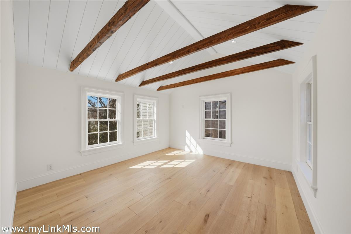 85 Orange Street Nantucket, MA 02554 - Photo 52 of 89 a view of an empty room with wooden floor and windows