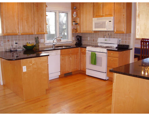 93 Spiers Road Newton, MA 02459 - Photo 2 of 11 a kitchen with stainless steel appliances kitchen island granite countertop a sink and a stove