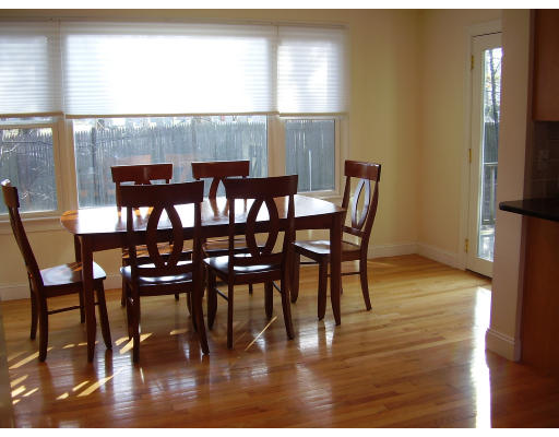93 Spiers Road Newton, MA 02459 - Photo 4 of 11 a dining room with furniture a chandelier and wooden floor