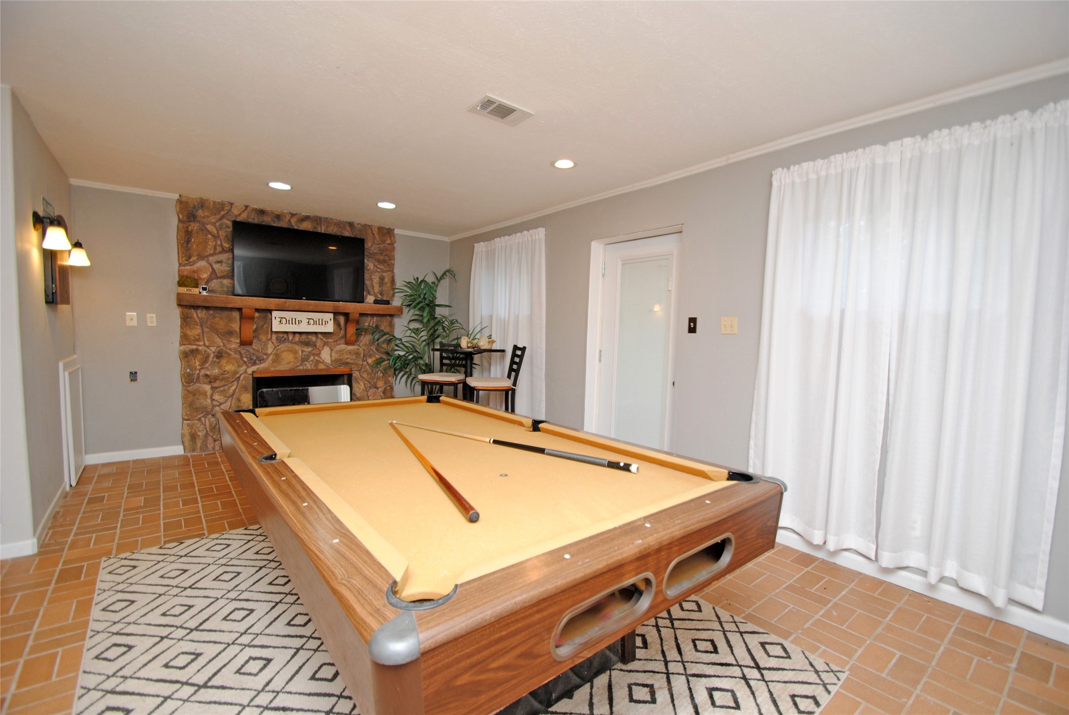 59 Paradise Loop Point Blank, TX 77364 - Photo 19 of 39 On the lower level you will find a large game room with a wood burning fireplace.