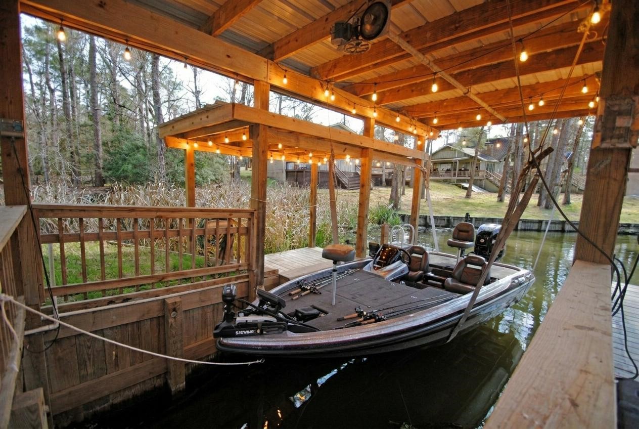 59 Paradise Loop Point Blank, TX 77364 - Photo 35 of 39 Boat dock comes complete with a lift.