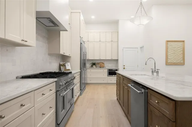 a kitchen with a sink stove top oven and cabinets