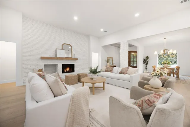 a living room with furniture fireplace and a chandelier