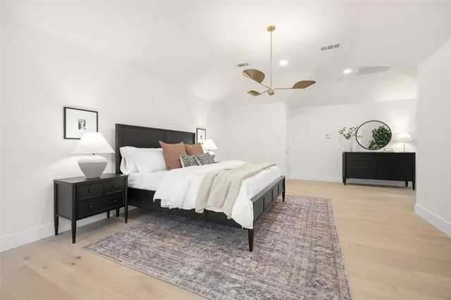 a bedroom with a bed and a chandelier