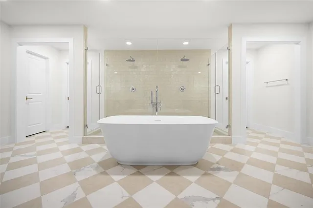 a bathroom with a bathtub and a shower