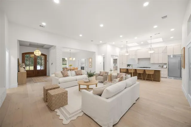 a living room with furniture and kitchen view