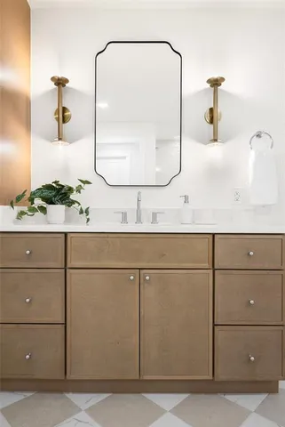 a bathroom with a sink and mirror