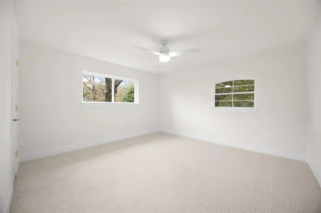 an empty room with windows and closet