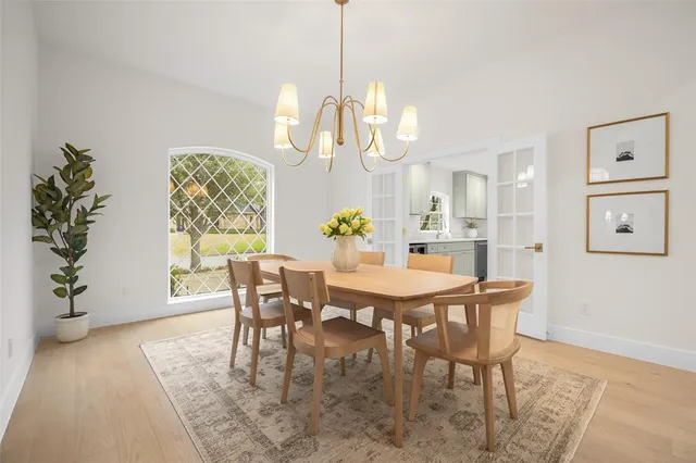 a view of a dining room with furniture and chandelier