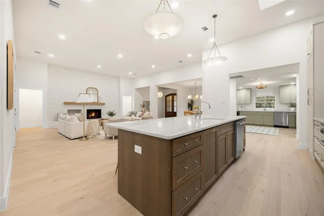 a kitchen with kitchen island a large counter top and appliances