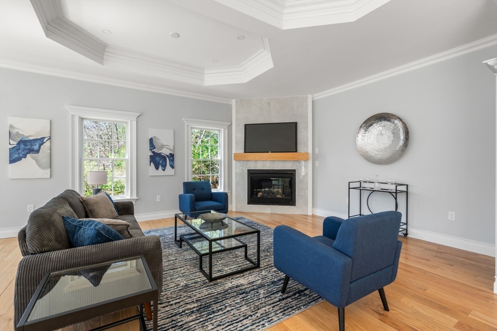 10 Hitching Post Lane Weston, MA 02493 - Photo 9 of 42 a living room with furniture a fireplace a rug and a window