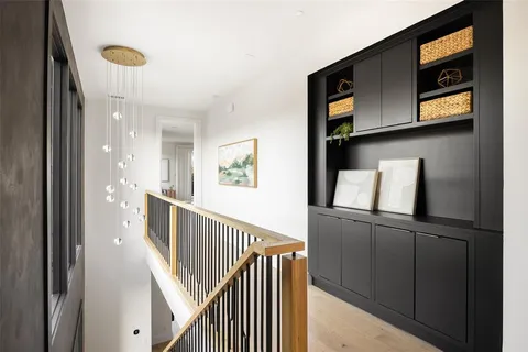 a bedroom with a bed and large windows