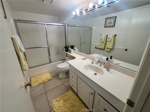 a bathroom with a sink mirror vanity and toilet